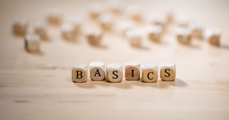 Wooden letter blocks that read the word "BASICS"