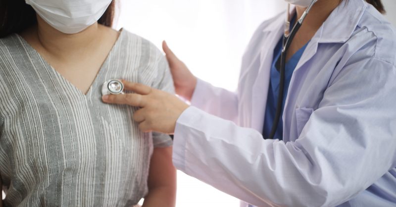 Physician listening to heartbeat of patient.